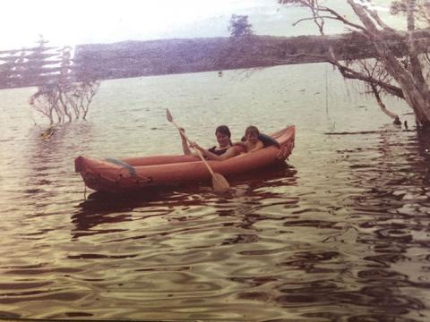 Photo of Angela Arthington and her son in a boat on the water in the 1970s