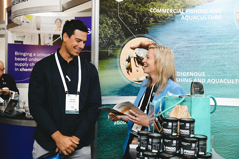 FRDC Research Portfolio Manager Adrianne Laird chats to Bryan Van-Wyk of Austral Fisheries at the FRDC stand.