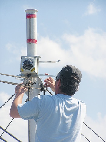 Photo of man Attaching camera to mast.