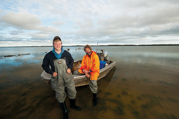 Photo of Tucker Sheehan and Glen Hill on a boat