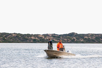 Photo of Tucker Sheehan and Glen Hill in a boat on the Coorong lagoon