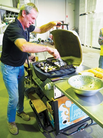 Photo of Olaf Hansen barbecuing pipis