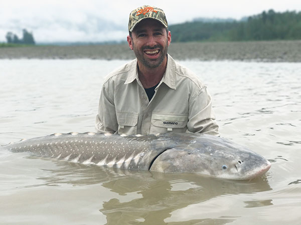 Photo of Jamie Crawford holding Whitte Sturgeon in Canadra"s Fraser River