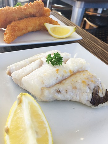 Photo of grilled Blue Grenadier and lemon wedge