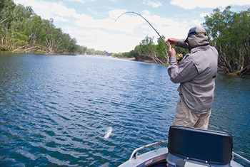 Photo of man fishing from boat