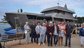 Photo of the Abbott family with its new catamaran D&D.
