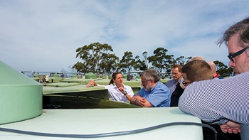 Photo of Manager of the Experimental Aquaculture Facility at Taroona, Polly Hilder (left), explaining the Atlantic Salmon research underway to visitors.