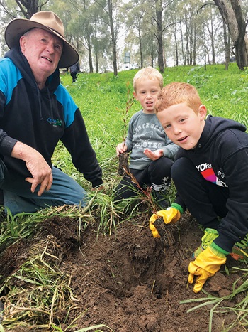Photo of kids helping Mick O"Neill on National Tree Planting Day