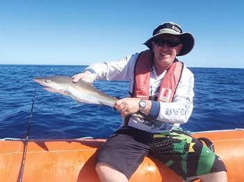 Photo of Colin Simpfendorfer holding a fish