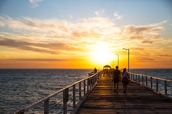 Photo of people walking on pier at Henley Beach, SA