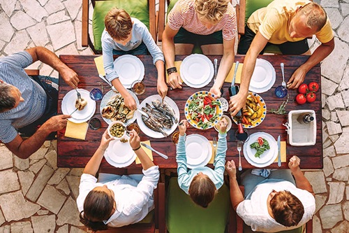 Photo of family eating food at a table