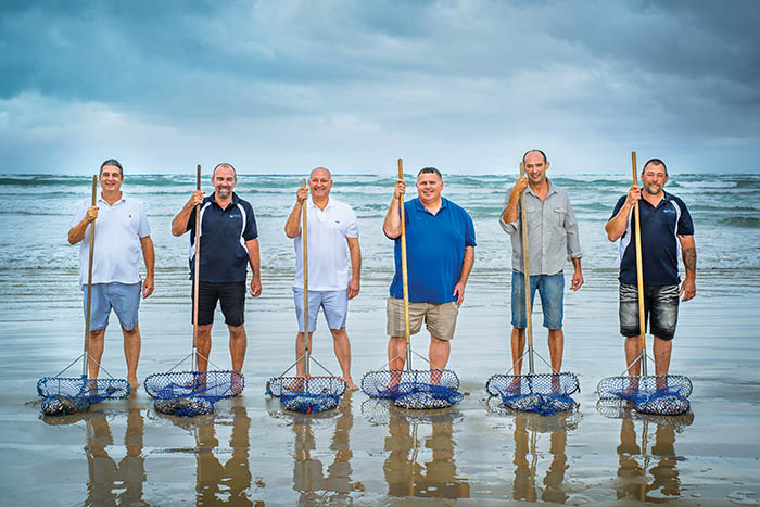 Photo of Goolwa PipiCo directors at the beach holiding Pipi nets