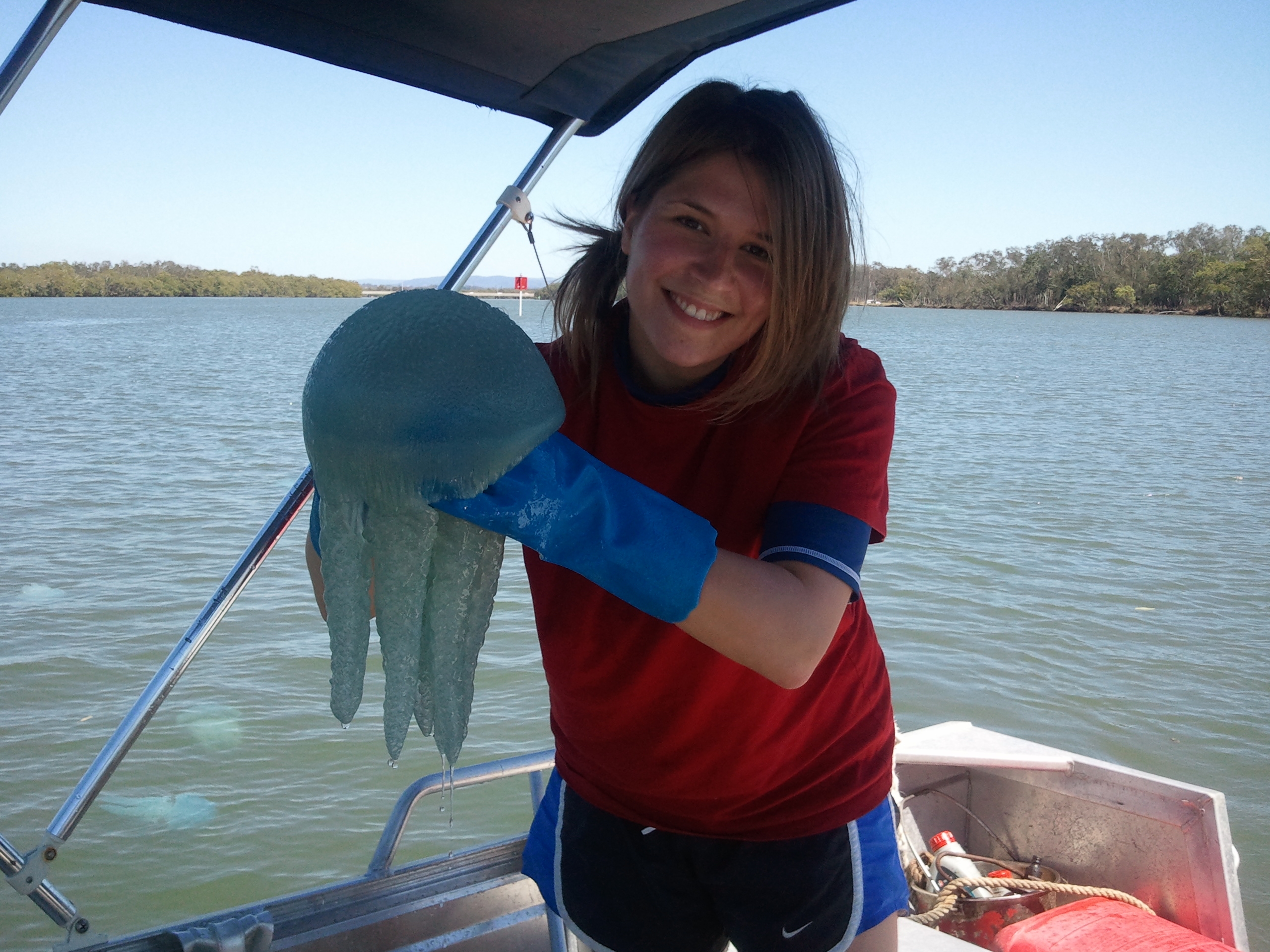 Former PhD student Ariella Budarf holding a jellyfish