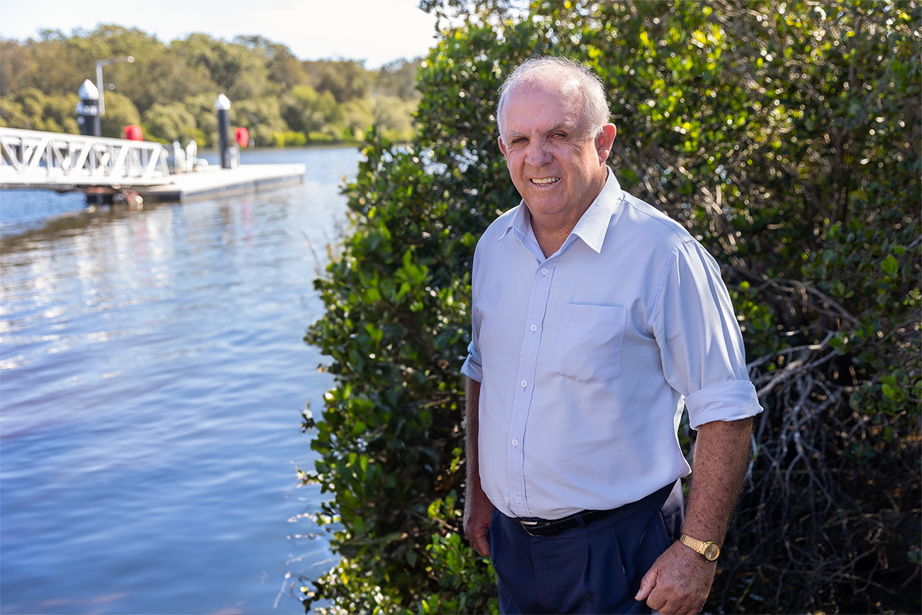 John Williams standing near bush and water - Port stephens